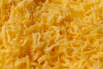 grated cheese of orange color preparation for adding to dishes