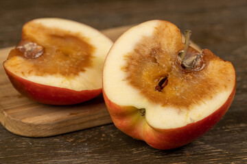 apple that has begun to deteriorate and become covered with rot due to long storage or damage,...