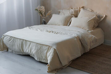In a cozy bedroom, there is a neatly made bed adorned with crisp white sheets and fluffy pillows, inviting a restful sleep