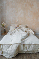 A cozy bed adorned with crisp white sheets and plush pillows, situated in a beautifully arranged bedroom that invites relaxation
