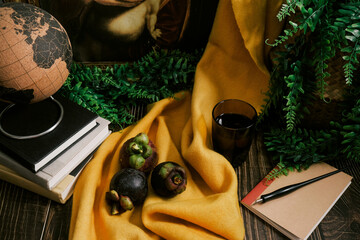 Still life set up on wooden table with three purple Mangosteen fruit, classic painting replica,...