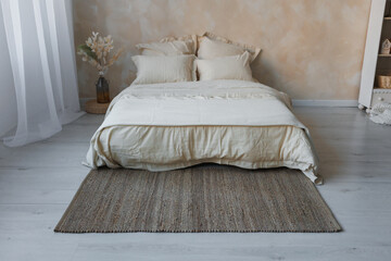 A cozy bedroom featuring a comfortable bed along with a soft rug spread on the floor, adding warmth to the space
