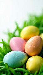 Speckled and solid Easter eggs rest on lush green grass, set against a pure white background , easter eggs, cheerful, decoration