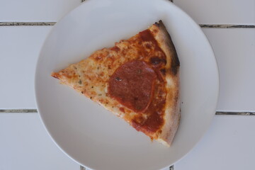 Slice of pepperoni pizza on a plate