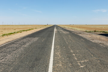 Wide road stretching across the vast landscape of Akzhaik District in West Kazakhstan Region