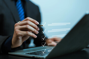 Businessman working on computer using laptop. Concept of business performance tracking and evaluation. Document management system DMS. Performance checklist evaluation form. 