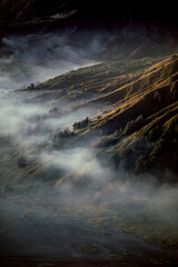 Aerial view of misty mountain valley at sunrise