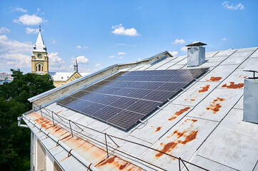 House with solar panels on rooftop for generating electricity through photovoltaic effect. Home...