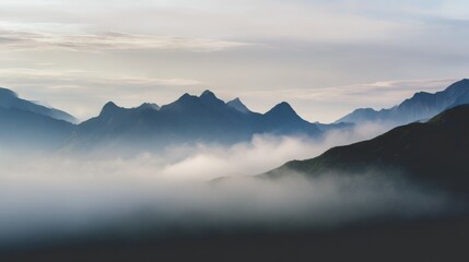 Fototapeta premium Misty mountain landscape at dawn with soft fog over peaks and dramatic lighting in a serene quiet atmosphere Generative AI