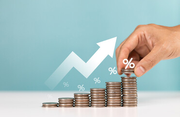Invest,Investment,interest rates,dividends,deposits and saving money. Upward arrows with increasing piles of coins indicating investment growth percentage
