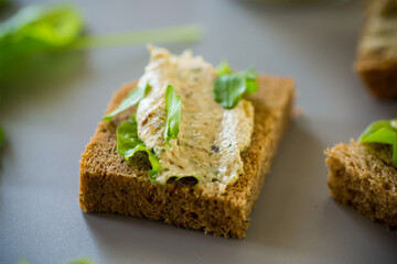 Homemade snack of rye bread with arugula and salad