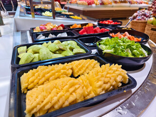 A salad bar featuring an extensive variety of fresh vegetables and fruits