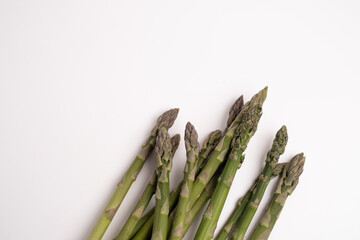 Green asparagus on a light background. Bunch of ripe fresh asparagus. Healthy organic food. Cook at home. Natural vitamins, raw materials for food. Handpicked Bio Asparagus