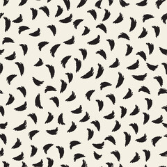 Vector seamless pattern featuring scattered brushstroke elements in various directions, creating a lively, dynamic composition. The black ink-like shapes on a light background give a hand-painted