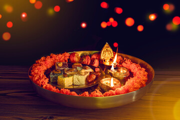 Tray with Diwali treats. Diwali lamp diya or Deepavali Deepawali. Hindu festival of lights....