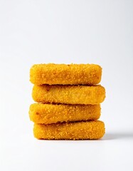 Fototapeta premium Stacked golden fish sticks on white background showcasing crunchy texture