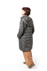Woman seen from behind, full body with dark green coat.