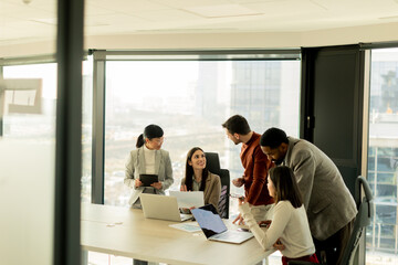 Collaboration among diverse professionals in modern office space during a strategic meeting
