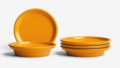 Stacked, bright yellow dinnerware set on white. Plain ceramic plates
