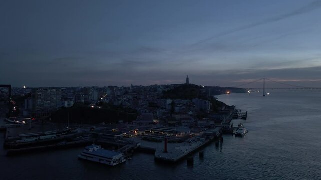 Power Outage in Almada. Dark City, Bridge and Tagus River at Evening Twilight. Portugal. 2025 Iberian Peninsula Blackout. Aerial View