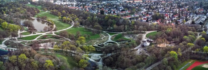 Panoramic View of Westpark and part of Munich city from above. Aerial drone shot. Trees and bushes are still partially leafless. Spring has arrived.