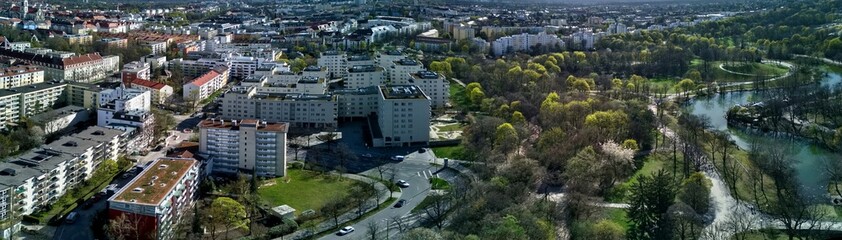 Panoramic View of Westpark and part of Munich city from above. Aerial drone shot. Trees and bushes are still partially leafless. Spring has arrived.