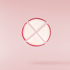 Fresh raw Red Radish with green leaves falling in the air isolated on pink backgriund. Food...