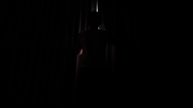 Asian man opens curtains in morning at bedroom for warm morning light, hand pulling window curtains with light shining beautifully through the curtains, Footage slow motion horizontal 4K.