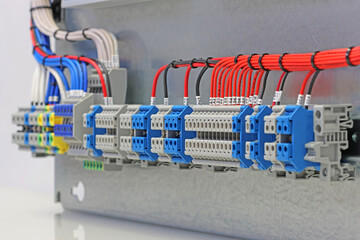 Electrical terminals with connected insulated copper wires with metal lugs. Marking with a thermal printer. 