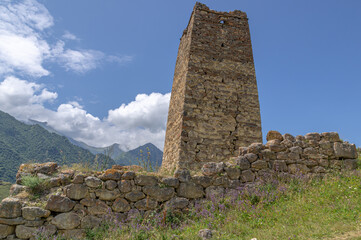 A dilapidated medieval architectural complex located high in the mountains. The largest mountain...