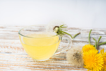 Dandelion tea in a transparent cup. Healthy herbal tea.