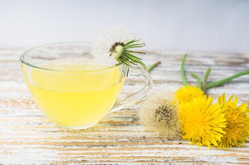 Dandelion tea in a transparent cup. Healthy herbal tea.