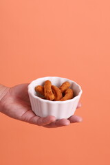 Hand holding Chicken Sticks