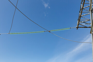 Insulators on power transmission line under clear blue sky