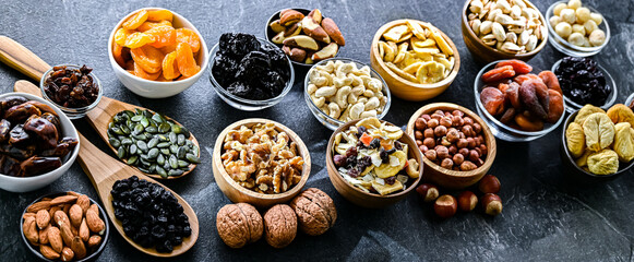 Composition with a variety of dried fruits and assorted nuts.