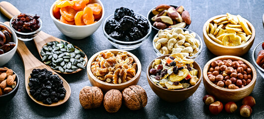Composition with a variety of dried fruits and assorted nuts.