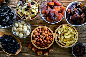 Composition with a variety of dried fruits and assorted nuts.