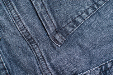 Naklejka premium Close-up of the seam and texture on grey jeans.
