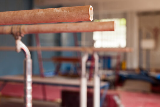 Interior of gym with old exercise machines, parallel bars and pommel horse