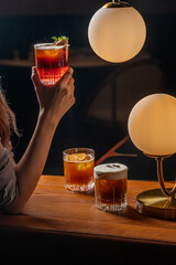 Elegant Cocktails Amber Hues and Golden Lighting in a Dark Bar