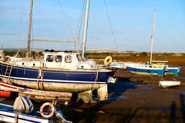 Fishing boats in the evening sun on the beach of Santa Luzia, Algarve, Portugal