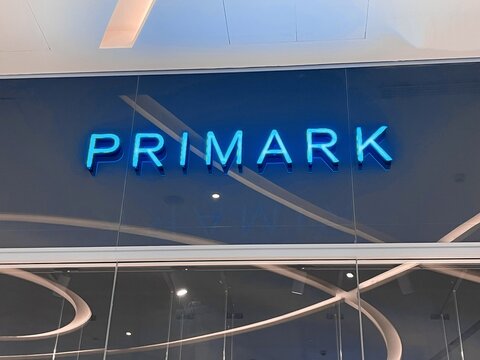 Province of Florence, Italy, March 24th 2025, Primark logo sign on storefront above shop window mannequins presenting their brand of fast fashion.