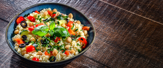 A plate of couscous served with vegetables and chickpeas