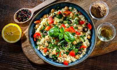 A plate of couscous served with vegetables and chickpeas