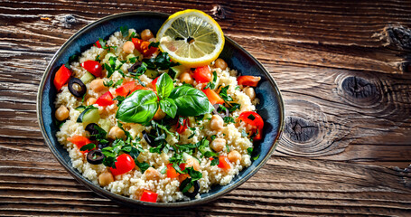 A plate of couscous served with vegetables and chickpeas