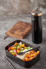 Healthy meal prep container with chicken, rice and vegetable salad. Back to school concept