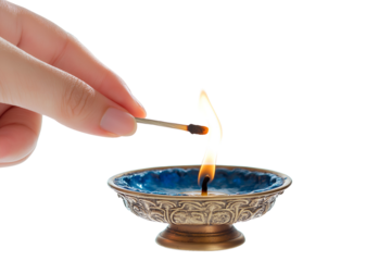 A hand lighting a candle with a Shamash during the eighth night, isolated on a white background 