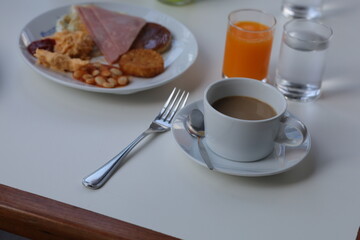 Classic breakfast set with ham, egg, bean, toast and juice.