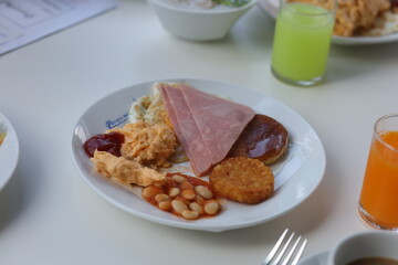 Traditional English breakfast with coffee and orange juice.