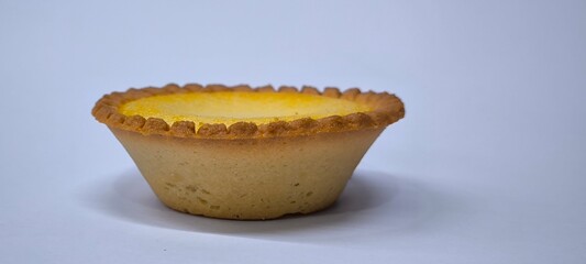 Egg tarts that are crispy on the outside and soft on the inside. Egg tarts that have a rich and creamy egg aroma. Egg tarts on white background.